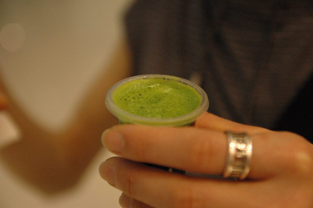 A small glass of freshly pressed green wheatgrass juice
