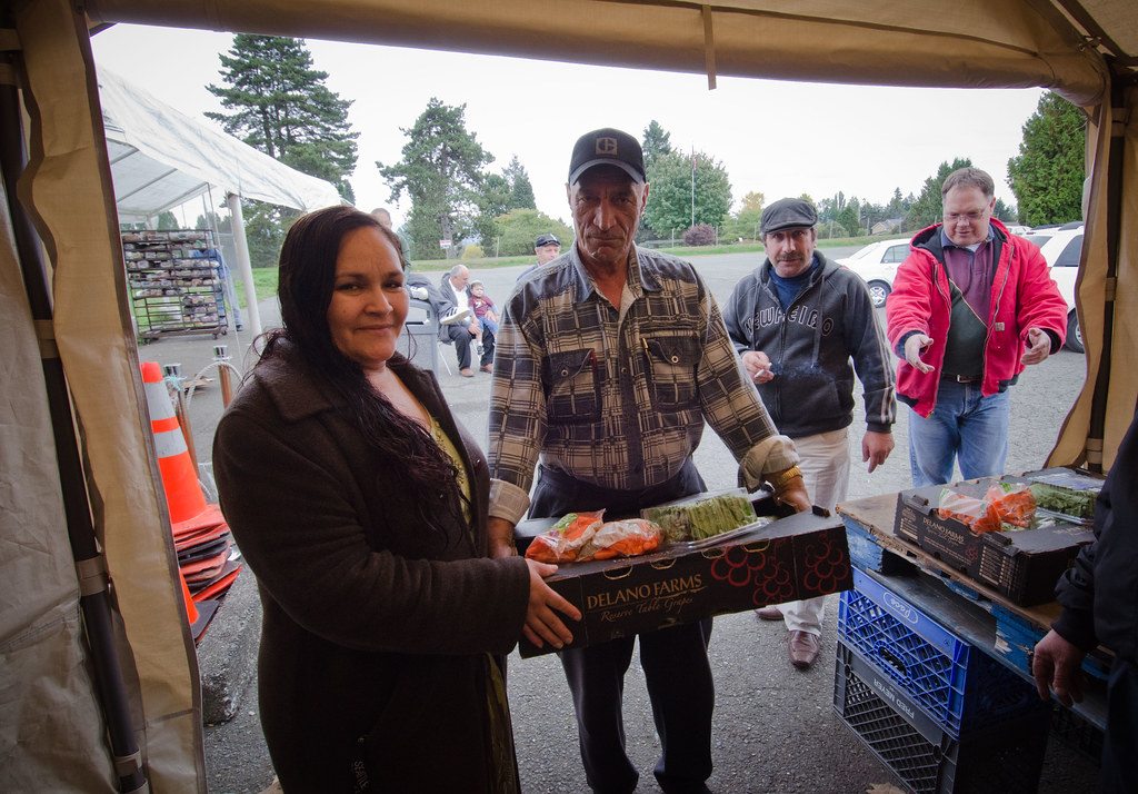 Workers inspecting produce in a distribution setting
